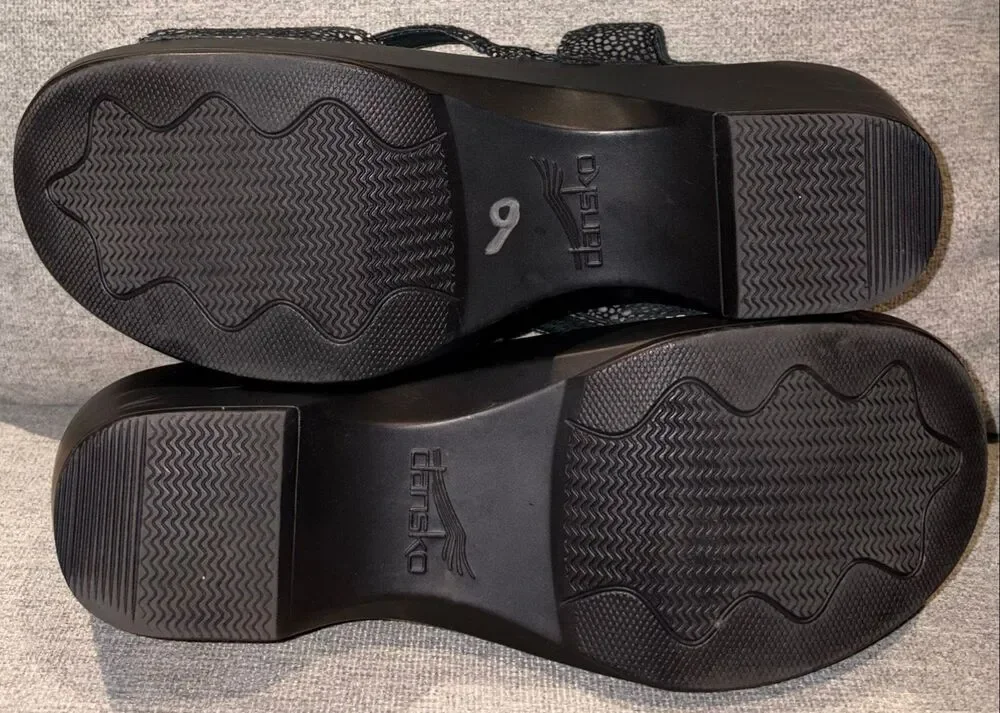 Dansko sandals, specifically the Sandi model featuring a black and white speckle